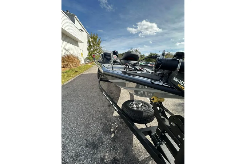 Slide: The Image of 2026 Tracker Pro Team 195 boat on trailer, parked outdoors under a clear sky. - 5