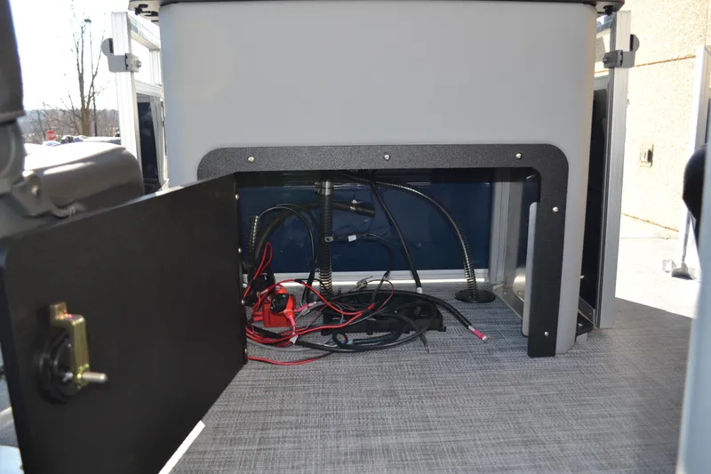 Slide: The Image of 2026 Sun Tracker SportFish 22 XP3 boat interior wiring and storage compartment. - 11