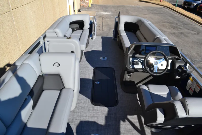 Slide: The Image of 2026 Sun Tracker SportFish 22 XP3 pontoon boat interior with gray seating and steering console. - 9