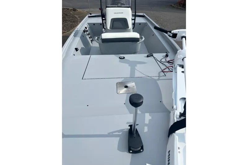 Slide: The Image of 2026 Tracker Bass Tracker Classic CC boat interior with steering console and fishing equipment. - 3