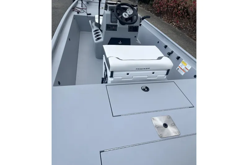 Slide: The Image of 2026 Tracker Bass Tracker Classic CC boat interior with steering console and seating. - 4