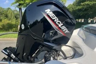 Slide: The Image of Mercury outboard motor on 2026 Tahoe T16 boat, parked outdoors. - 8