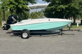 The Image of 2026 Tahoe T16 boat on trailer, parked outdoors with trees in background. - 0