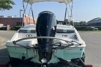Slide: The Image of 2026 Tahoe T16 boat with outboard motor, parked outdoors on a sunny day. - 3