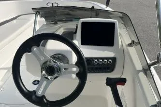 Slide: The Image of 2026 Tahoe T16 boat dashboard with steering wheel and control panel. - 6