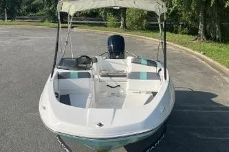Slide: The Image of 2026 Tahoe T16 boat with canopy, parked on a sunny day. - 1