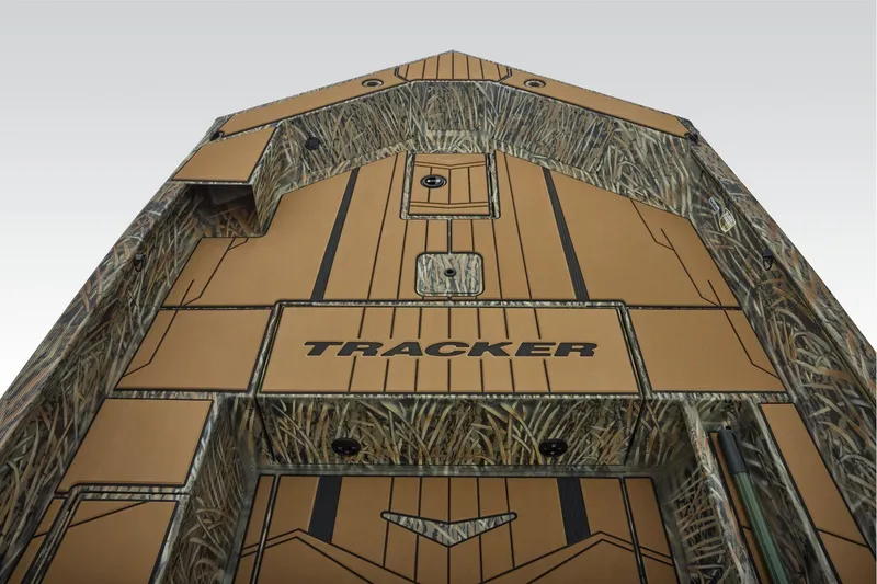 Slide: The Image of 2026 Tracker Grizzly 1756 T Marsh boat interior with camo design and tan decking. - 11