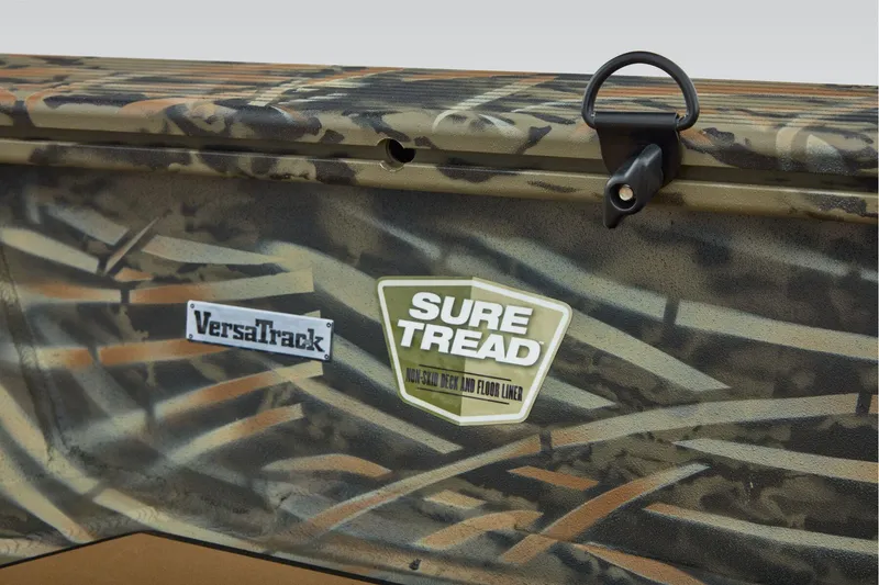 Slide: The Image of 2026 Tracker Grizzly 1756 T Marsh boat deck with camouflage and wood-like design. - 20