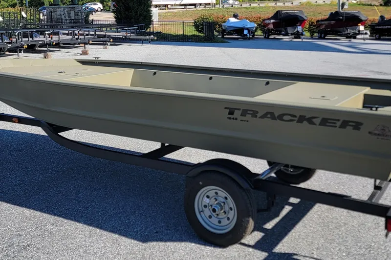 The Image of 2026 Tracker Grizzly 1648 Utility boat on trailer in outdoor setting. - 0