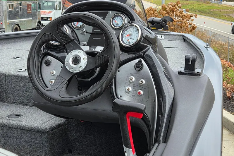 Slide: The Image of 2018 Tracker Pro Team 195 Tournament Edition boat dashboard with steering wheel and gauges. - 3