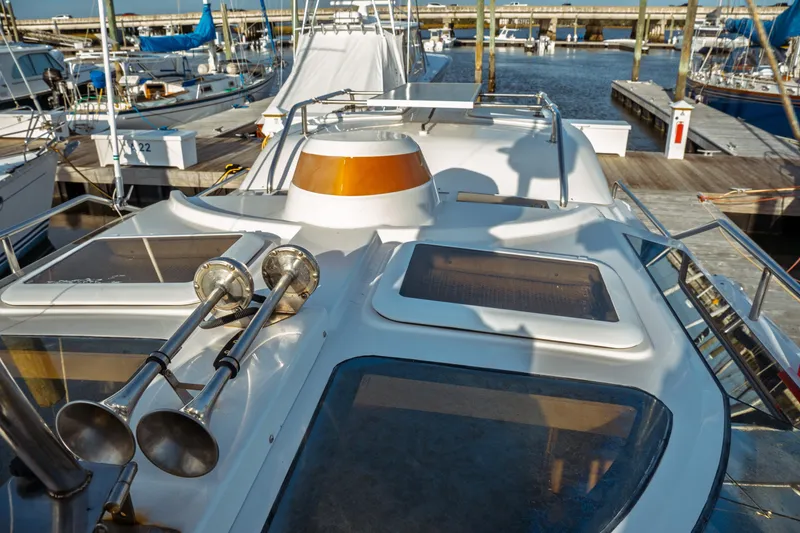 Slide: The Image of 2022 Ranger Tugs R-29 S yacht docked at marina, showcasing deck and horns. - 11