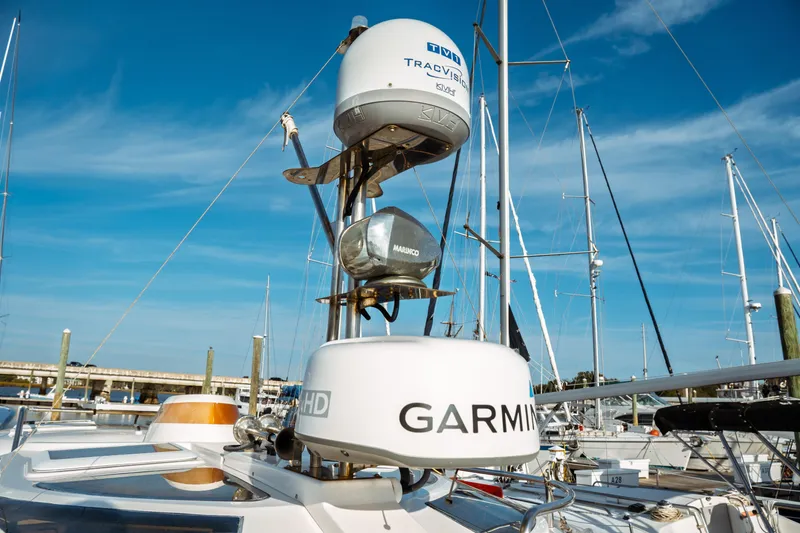Slide: The Image of 2022 Ranger Tugs R-29 S boat with advanced Garmin and TracVision equipment, docked under clear skies. - 13