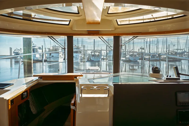 Slide: The Image of Interior view of 2022 Ranger Tugs R-29 S yacht overlooking marina. - 15