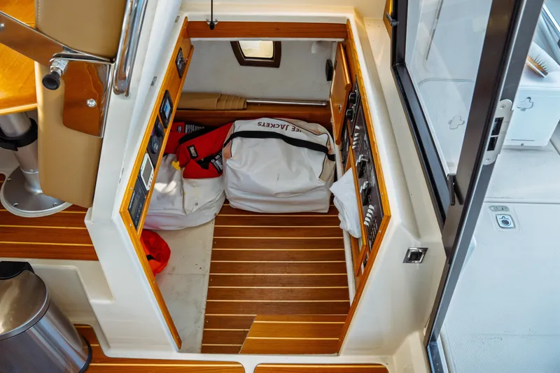 Slide: The Image of 2022 Ranger Tugs R-29 S interior with storage area and control panel. - 20