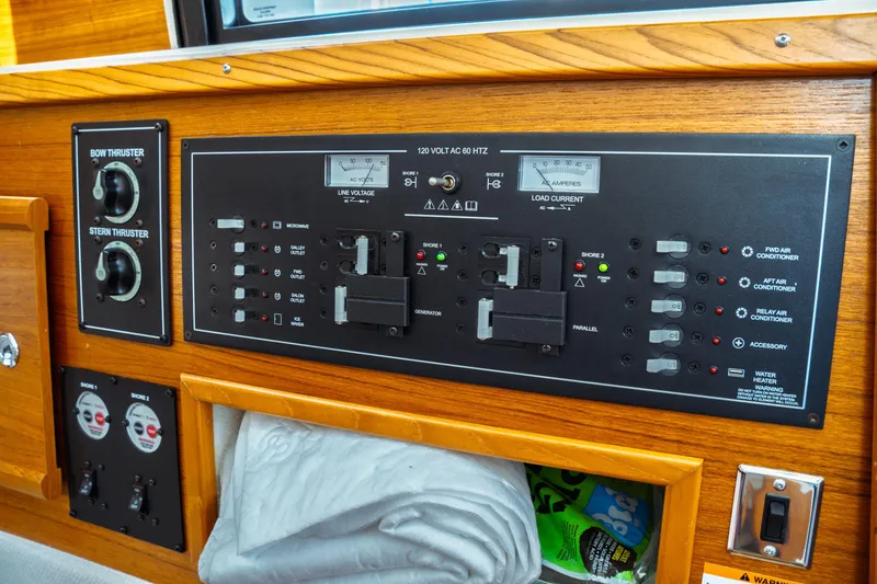 Slide: The Image of Control panel of 2022 Ranger Tugs R-29 S boat, featuring thruster and electrical switches. - 21