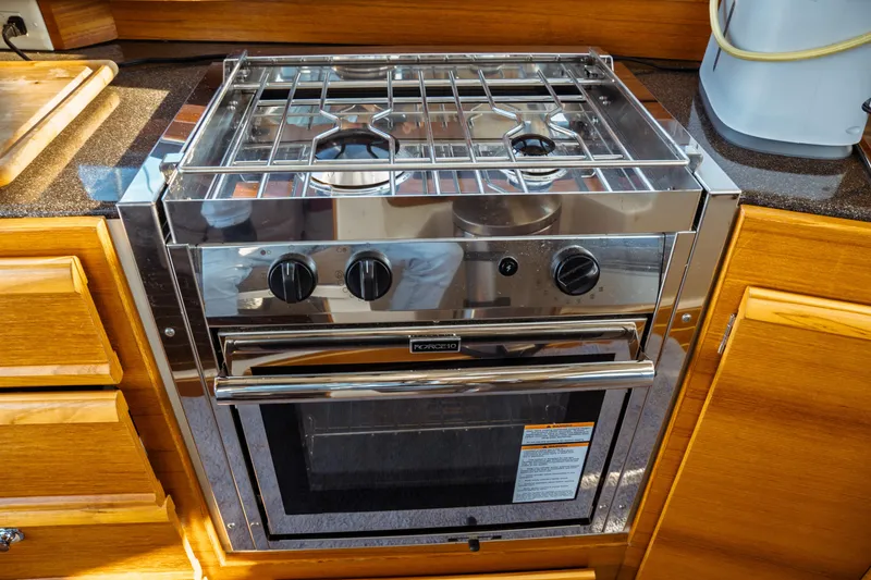 Slide: The Image of Stainless steel stove and oven in 2022 Ranger Tugs R-29 S boat kitchen. - 26
