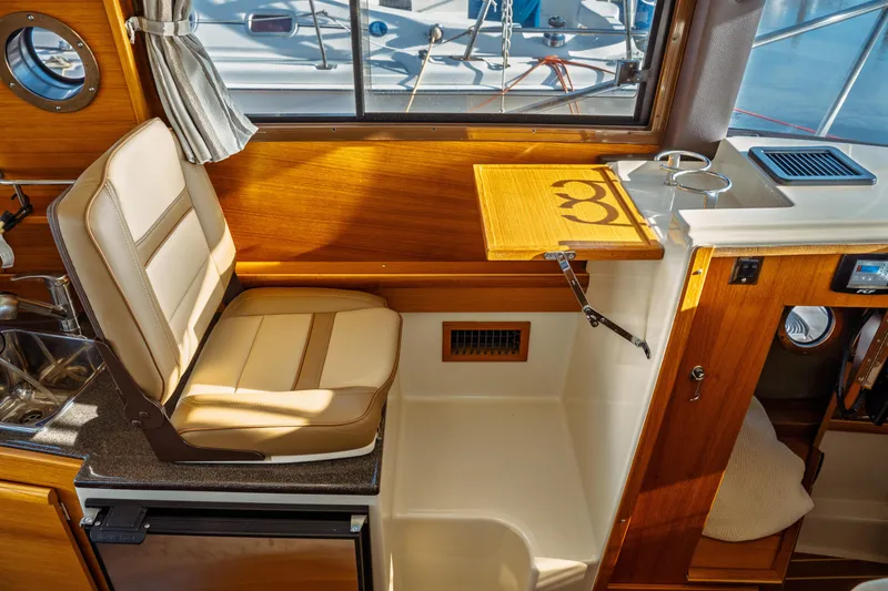Slide: The Image of Interior of 2022 Ranger Tugs R-29 S with seating and wooden accents. - 29