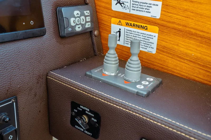 Slide: The Image of 2022 Ranger Tugs R-29 S control panel with warning labels and heater switch. - 37