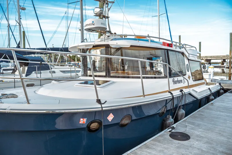 Slide: The Image of 2022 Ranger Tugs R-29 S docked at marina, featuring sleek design and modern amenities. - 4