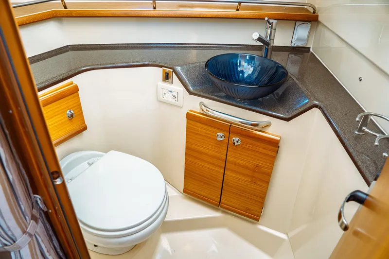 Slide: The Image of Luxurious 2022 Ranger Tugs R-29 S bathroom with modern sink and wooden cabinetry. - 42