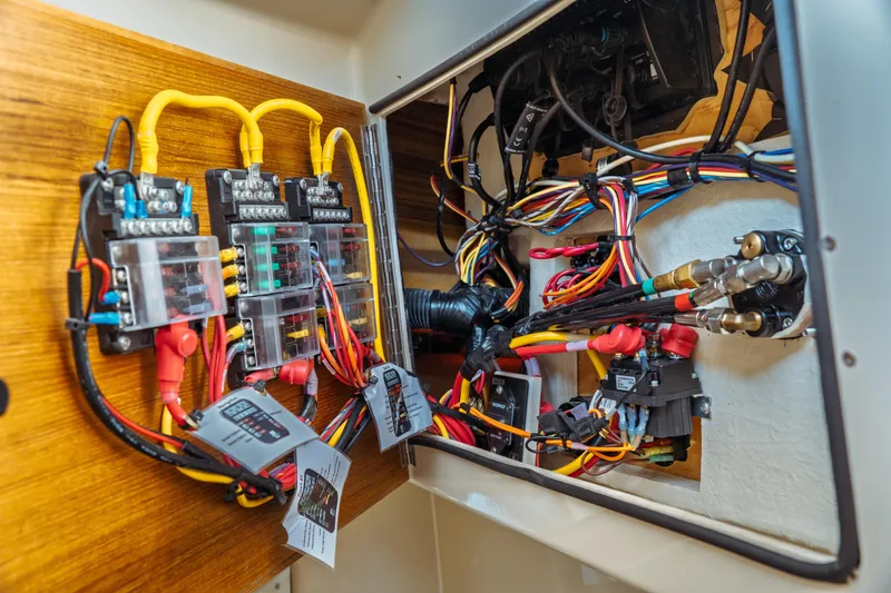 Slide: The Image of Electrical wiring system inside 2022 Ranger Tugs R-29 S boat, showcasing organized cables and connectors. - 45