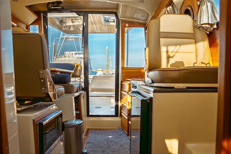 Slide: The Image of Interior of 2022 Ranger Tugs R-29 S boat, featuring seating and cabinetry. - 46