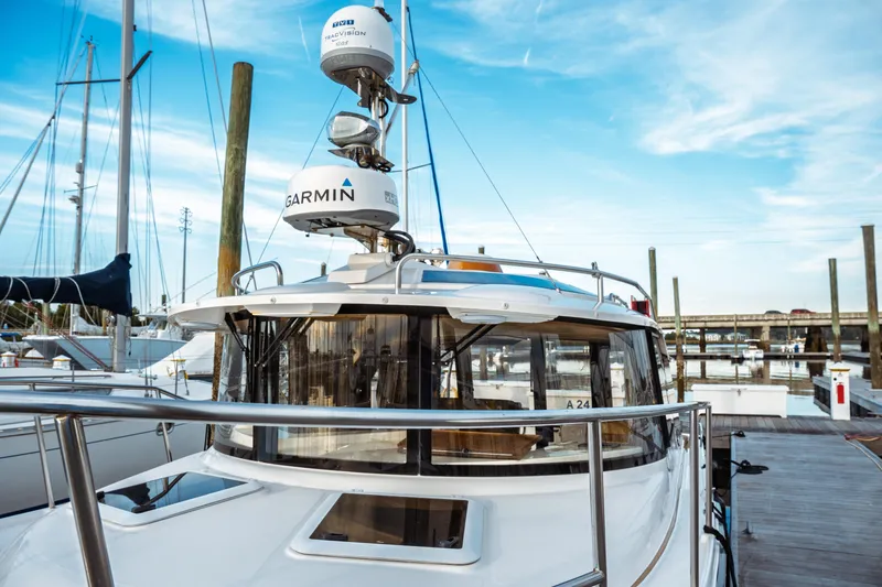 Slide: The Image of 2022 Ranger Tugs R-29 S docked, featuring Garmin equipment under a clear blue sky. - 7