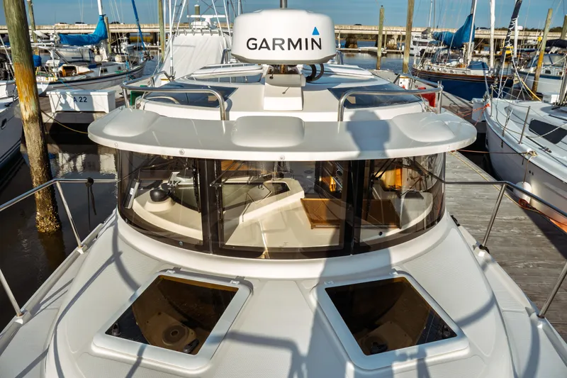 Slide: The Image of 2022 Ranger Tugs R-29 S boat docked, featuring Garmin navigation system. - 8