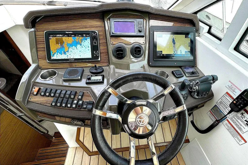 Slide: The Image of Helm of 2014 Cruisers Yachts 45 Cantius with navigation screens and controls. - 12