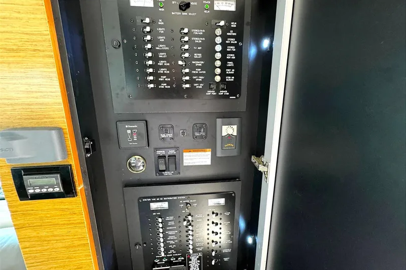 Slide: The Image of Electrical control panel inside 2014 Cruisers Yachts 45 Cantius, featuring switches and indicators. - 21