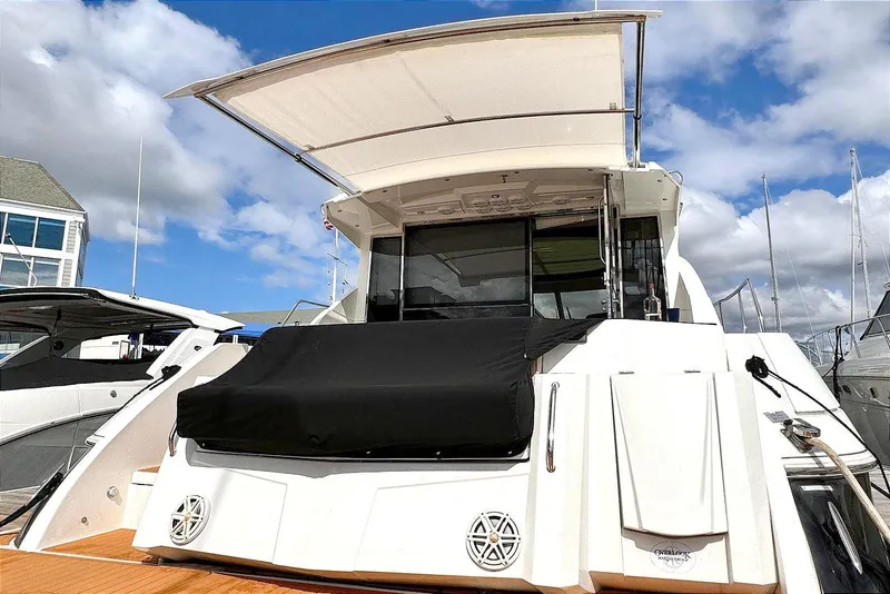 Slide: The Image of 2014 Cruisers Yachts 45 Cantius docked, showcasing sleek design and spacious deck. - 3