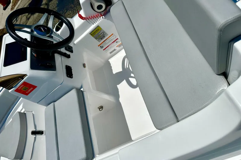 Slide: The Image of 2025 AB Inflatables Nautilus 11 DLX boat interior with steering wheel and seating. - 2