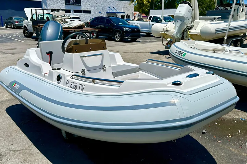 Slide: The Image of 2025 AB Inflatables Nautilus 11 DLX boat displayed outdoors in a dealership setting. - 3