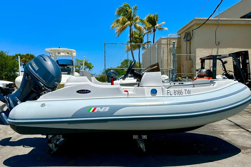 Slide: The Image of 2025 AB Inflatables Nautilus 11 DLX boat with Yamaha engine, parked outdoors. - 6