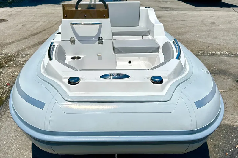 Slide: The Image of 2025 AB Inflatables Nautilus 11 DLX boat, sleek design, white exterior, docked on pavement. - 8
