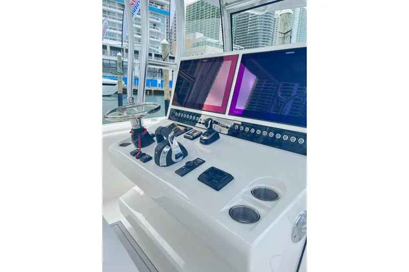 Slide: The Image of Helm of 2026 Tideline 365 Offshore boat with dual screens and controls. - 11