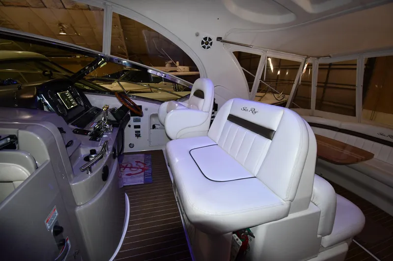 Slide: The Image of Interior of 2006 Sea Ray 40 Sundancer yacht with white leather seating and modern dashboard. - 12