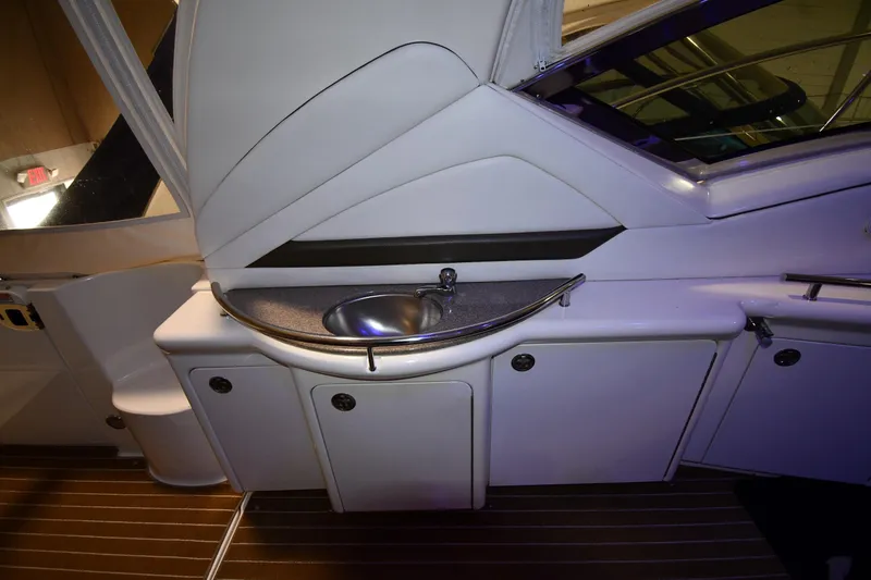 Slide: The Image of 2006 Sea Ray 40 Sundancer yacht interior with sink and storage cabinets. - 16