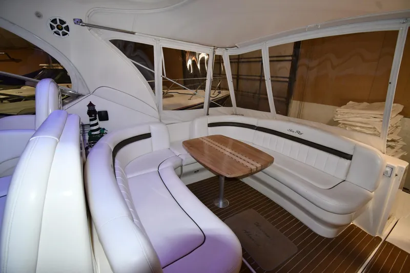 Slide: The Image of Luxurious interior of 2006 Sea Ray 40 Sundancer yacht with white seating and wooden table. - 19