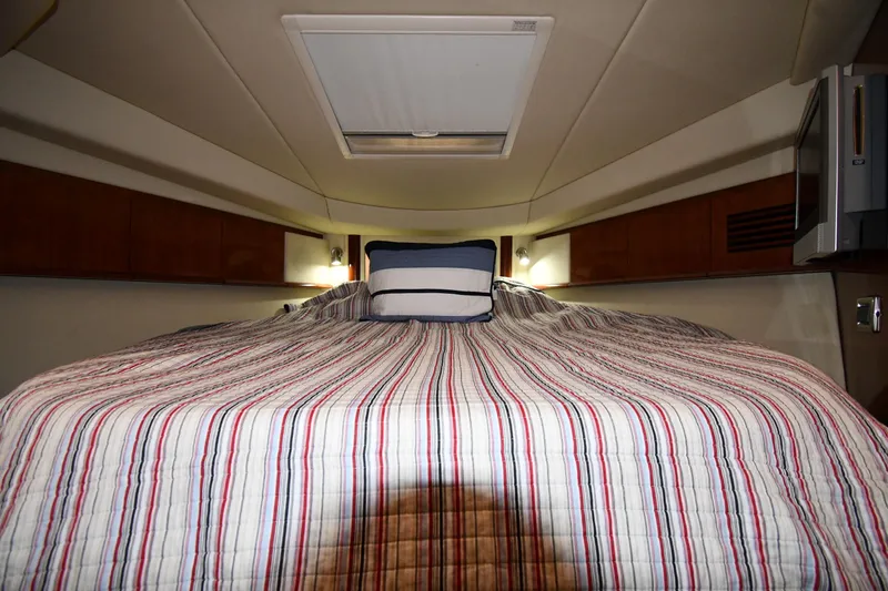 Slide: The Image of Interior cabin of 2006 Sea Ray 40 Sundancer with striped bedding and overhead hatch. - 25