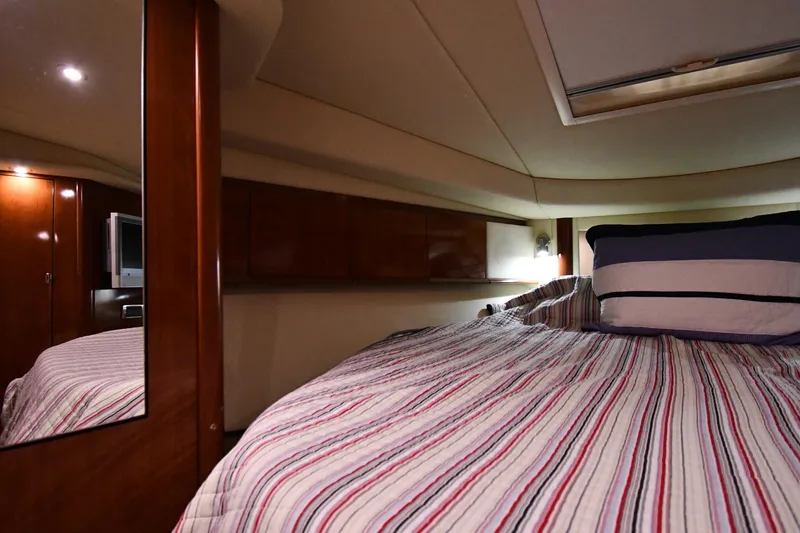 Slide: The Image of Luxurious cabin interior of 2006 Sea Ray 40 Sundancer yacht with striped bedding. - 27