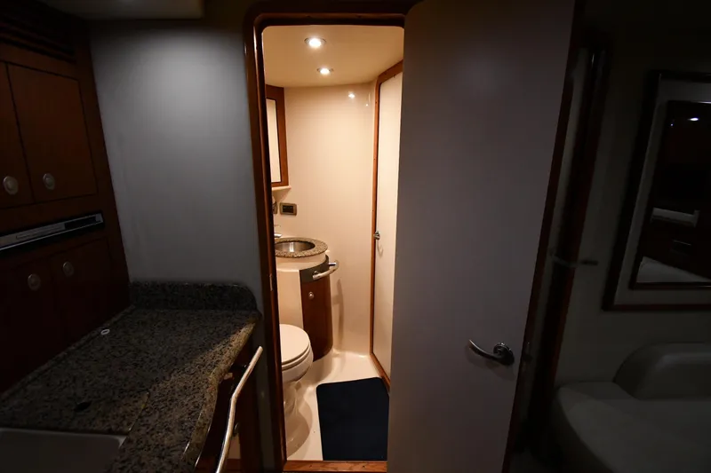 Slide: The Image of 2006 Sea Ray 40 Sundancer yacht bathroom interior with granite countertop and modern fixtures. - 32