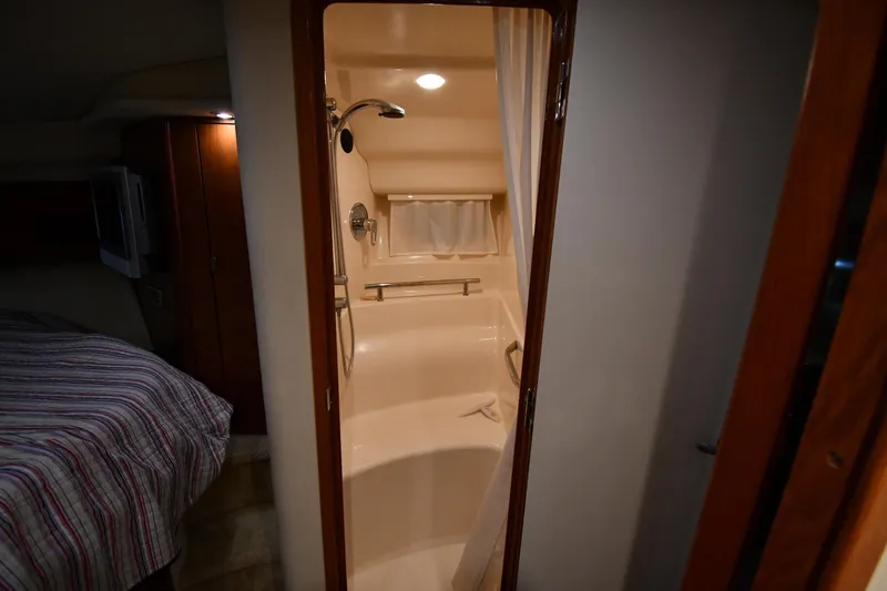 Slide: The Image of Interior of 2006 Sea Ray 40 Sundancer showing bathroom and adjacent bedroom area. - 34