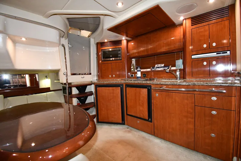 Slide: The Image of Luxurious 2006 Sea Ray 40 Sundancer yacht interior with elegant wood cabinetry and modern amenities. - 37