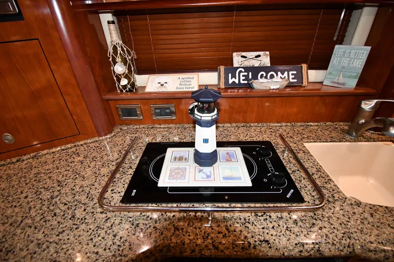 Slide: The Image of 2006 Sea Ray 40 Sundancer kitchen with lighthouse decor and granite countertop. - 40