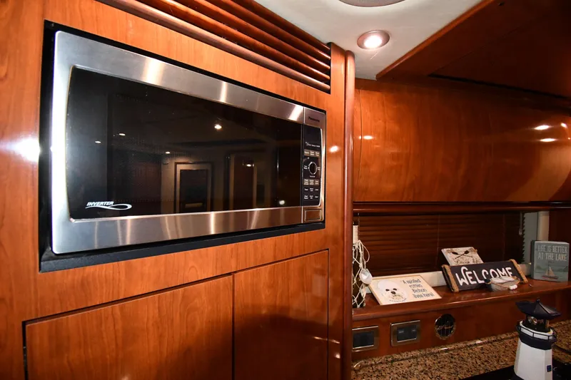 Slide: The Image of Luxurious 2006 Sea Ray 40 Sundancer kitchen with microwave and wooden cabinetry. - 41