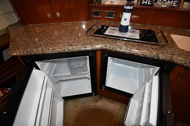 Slide: The Image of 2006 Sea Ray 40 Sundancer kitchen with granite countertop and open mini-fridges. - 42