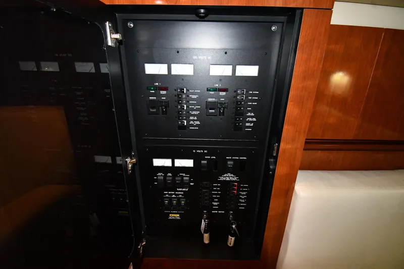 Slide: The Image of Electrical panel inside 2006 Sea Ray 40 Sundancer yacht, featuring switches and meters. - 47