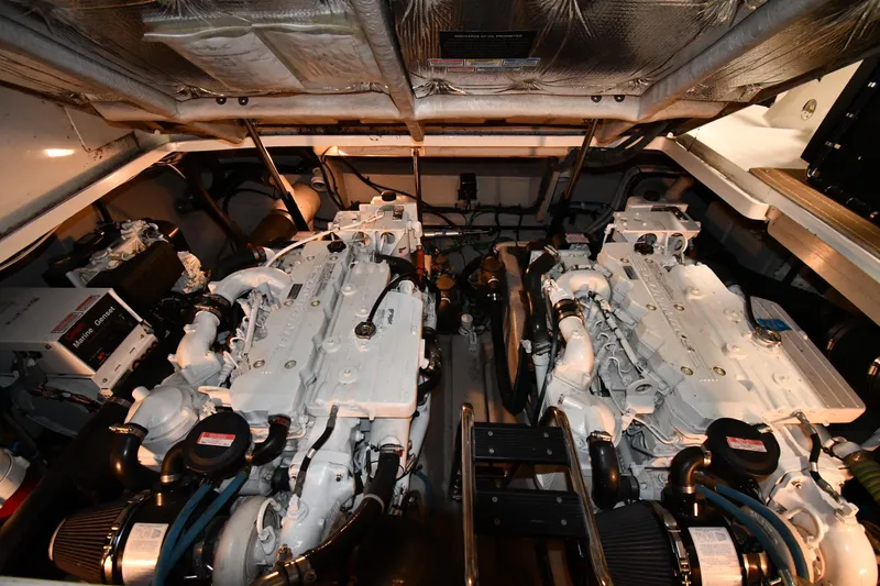 Slide: The Image of Engine room of a 2006 Sea Ray 40 Sundancer yacht, showcasing dual engines. - 48