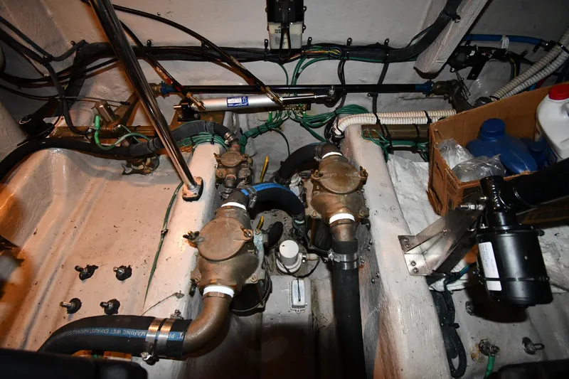 Slide: The Image of Engine room of 2006 Sea Ray 40 Sundancer with visible mechanical components and wiring. - 53